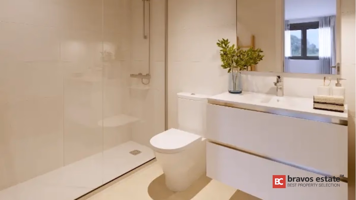 Modern bathroom with white vanity and glass shower in Alicante apartment