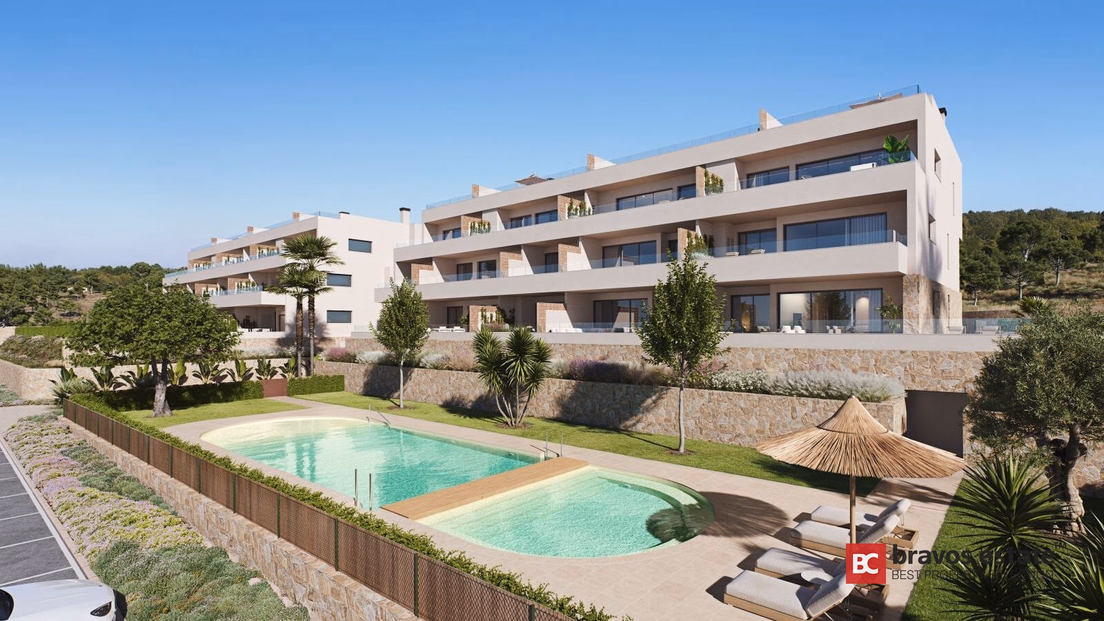 Citrus Las Colinas Golf apartment building with kidney-shaped communal pool, sunbeds, palm trees and Mediterranean landscaping