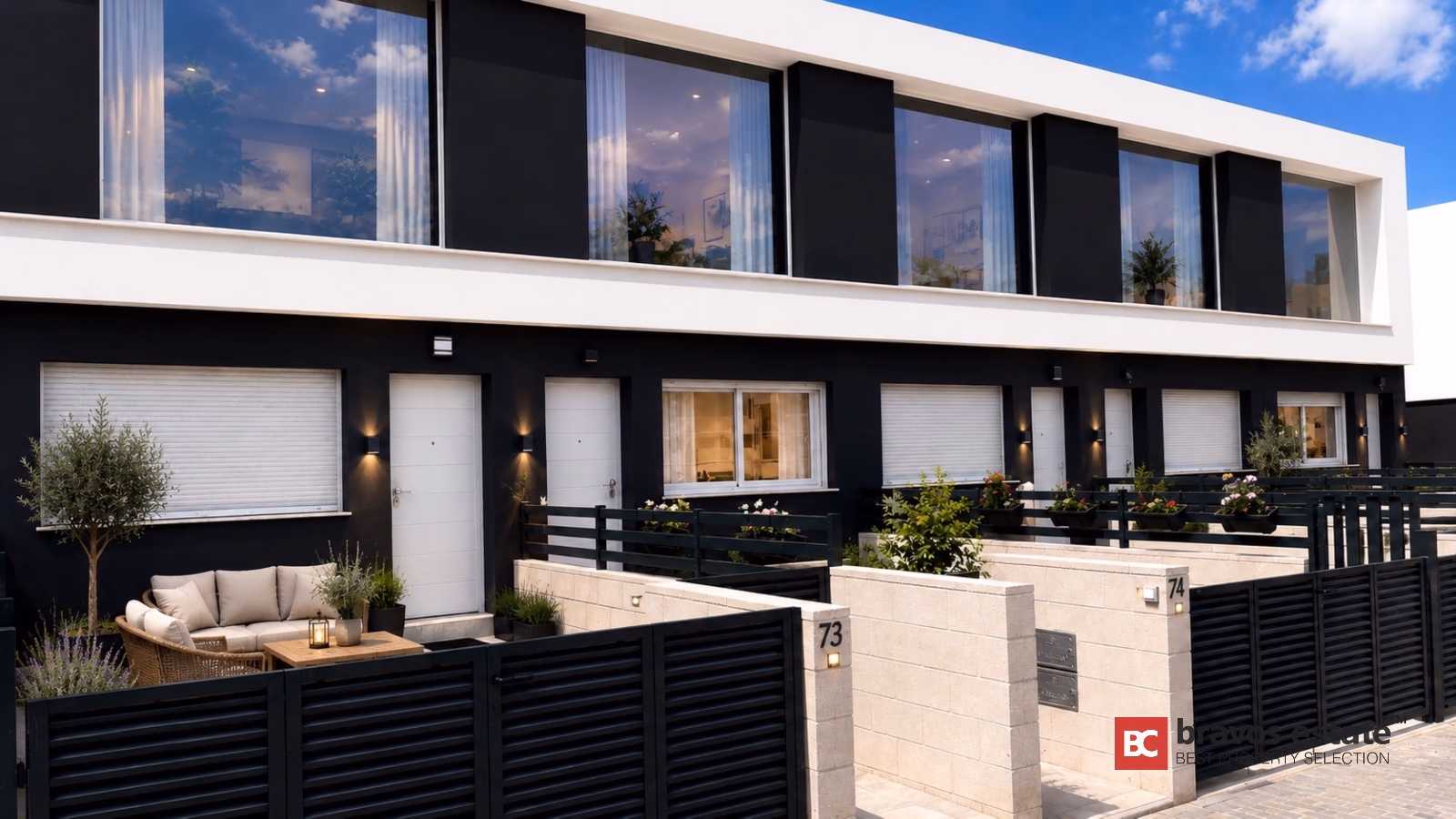 Contemporary black and white townhouse facade with horizontal slat fencing and private terrace in Gran Alacant