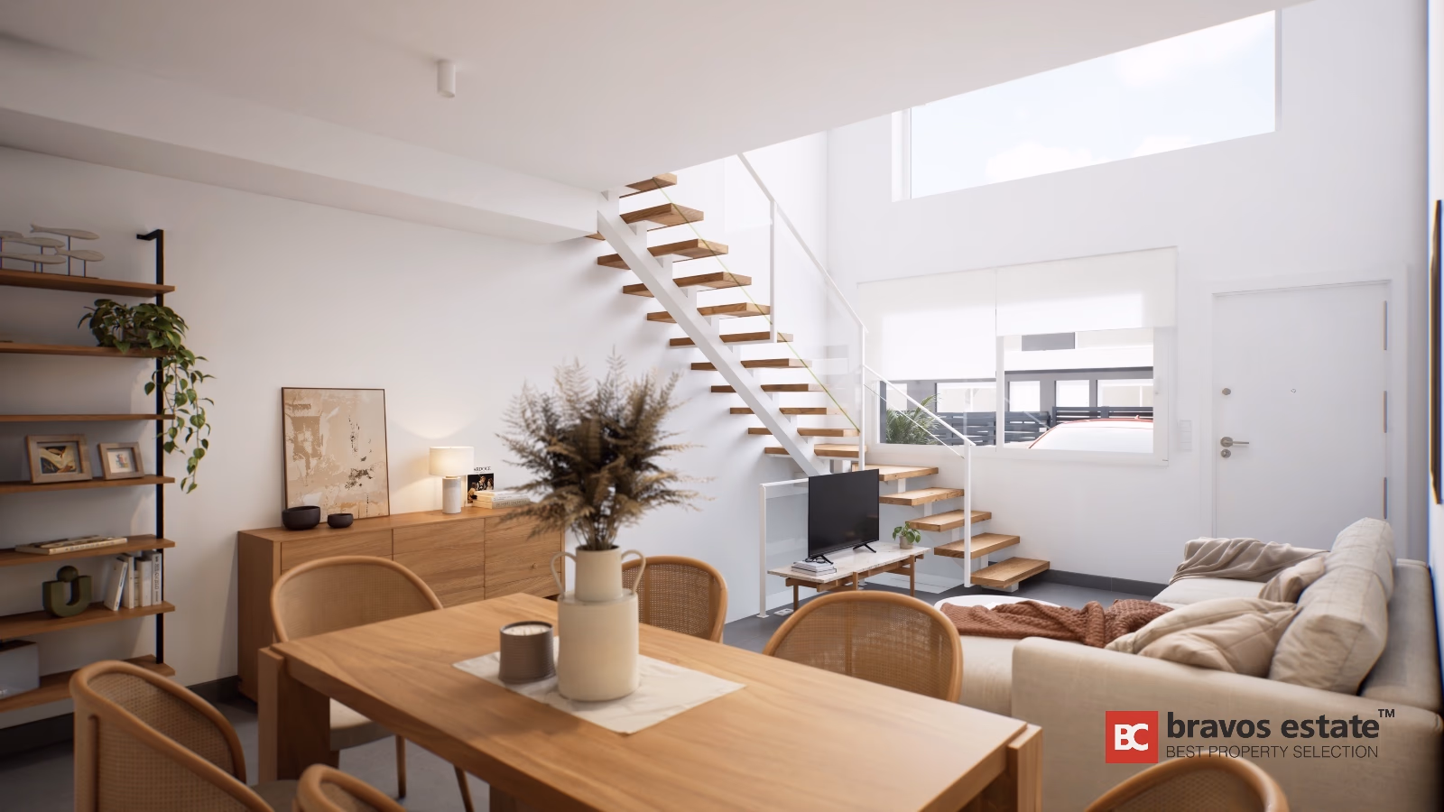 Open-plan living area with floating wood staircase and cane dining chairs in Gran Alacant townhouse