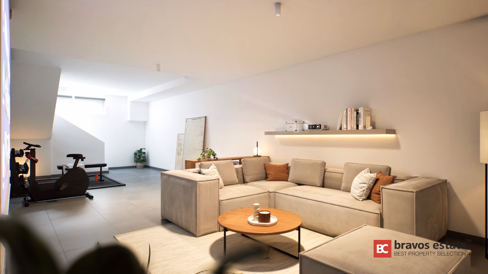 Open-plan living room with beige sectional sofa, floating LED shelf and exercise equipment in Gran Alacant townhouse