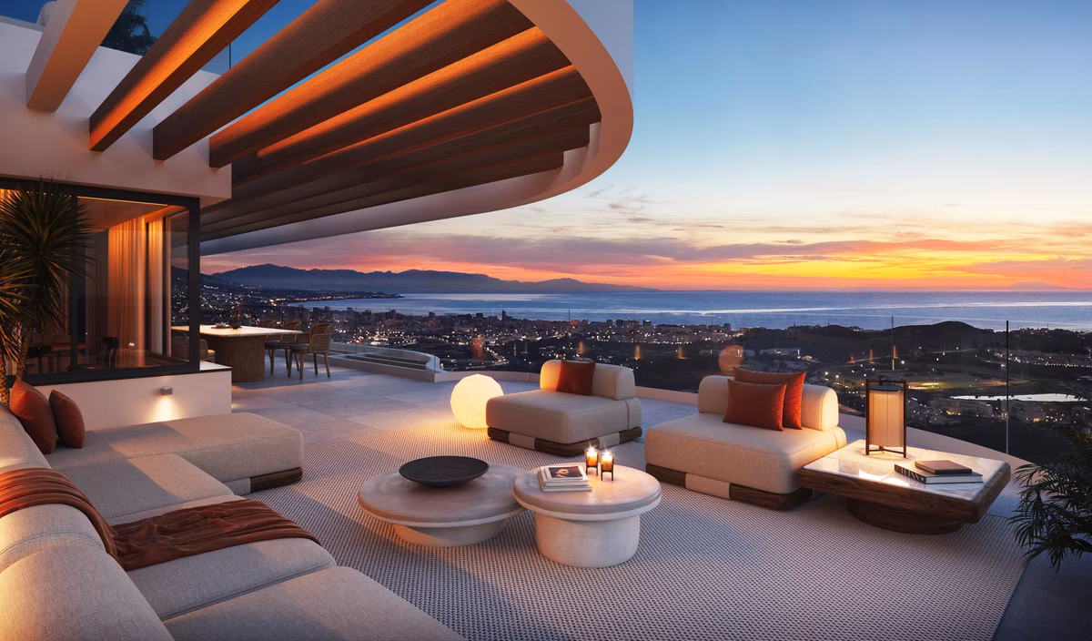 Penthouse terrace at dusk with curved pergola and coastal views
