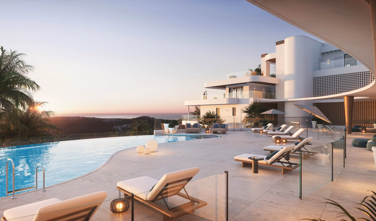 Outdoor pool with sun loungers at sunset