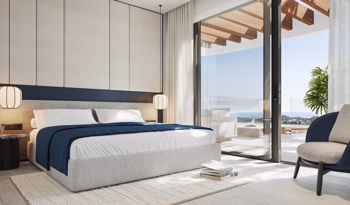 Bedroom opening onto a terrace with sea views