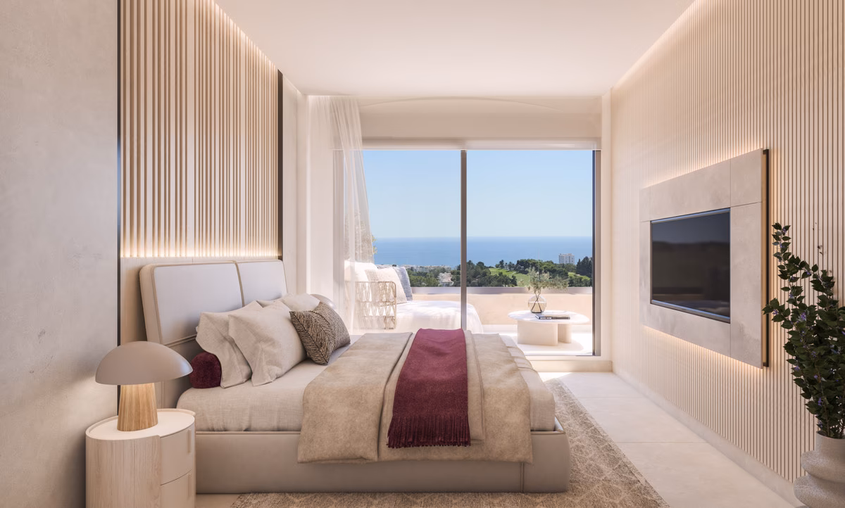 Dormitorio con rincón de estar y vistas a la costa