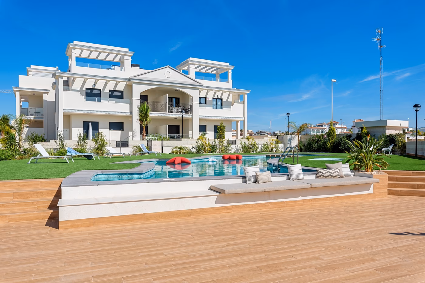 Raised timber sun deck beside the communal pool