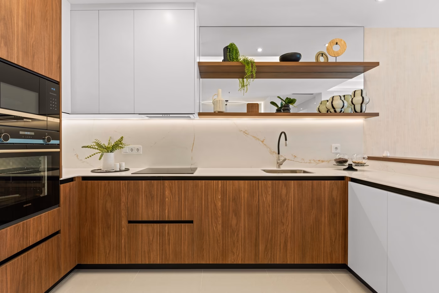 Fitted kitchen with built-in oven and tall fridge