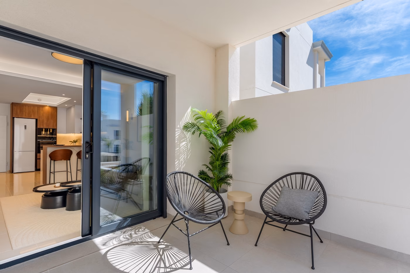 Covered terrace with chairs, seen from the living room