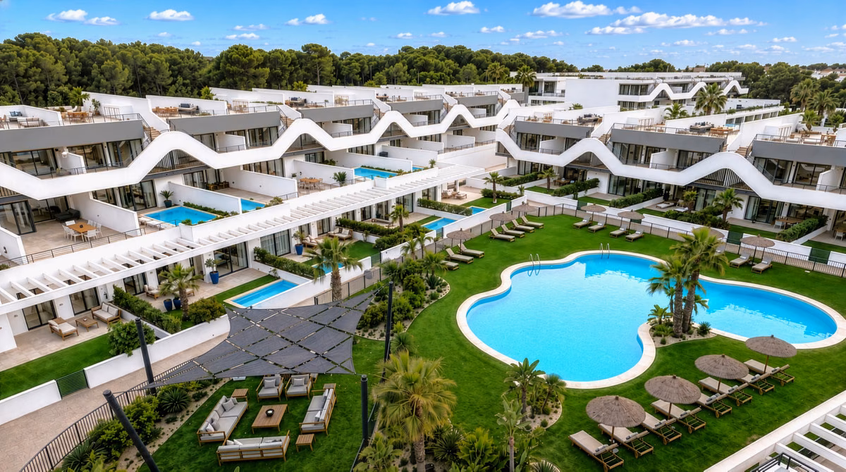 Poolside lawn and shaded seating between the Alfaz Essence blocks