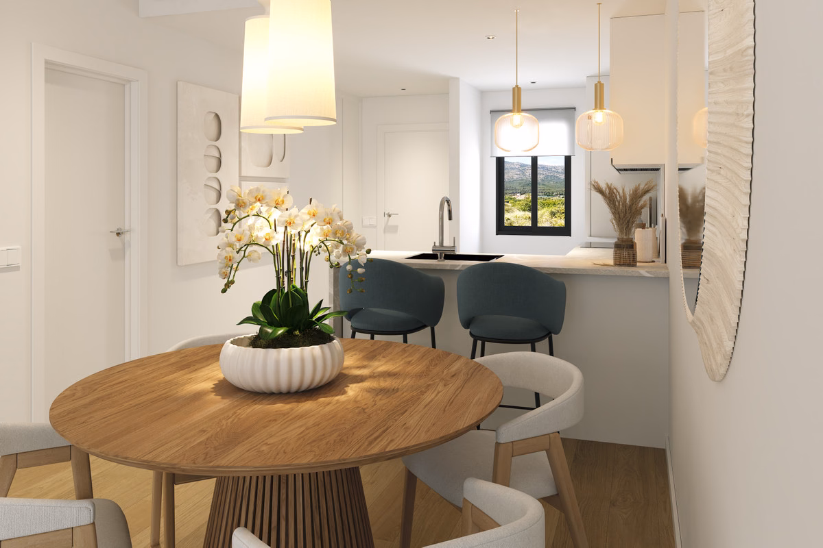 Dining area beside the open kitchen in an Alfaz Essence apartment