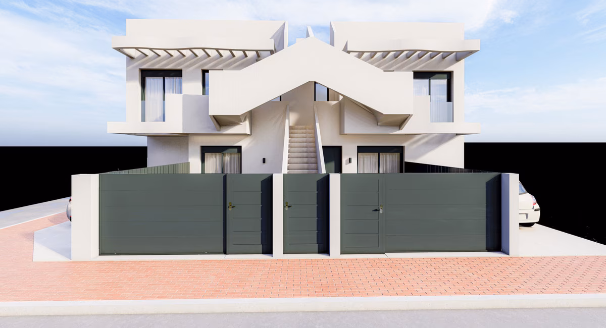 White facade of the four-home building with gated entrances and the central outside staircase