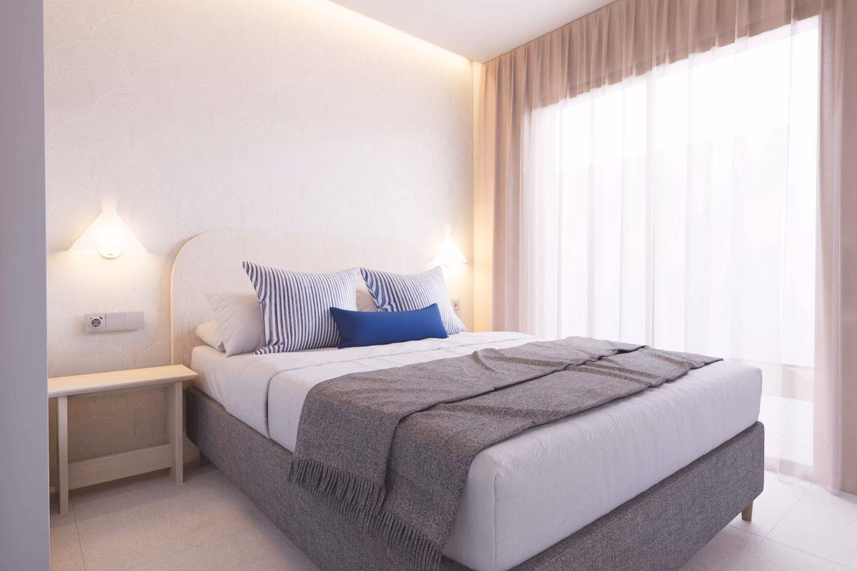 Double bedroom with a ceiling light and grey bedding