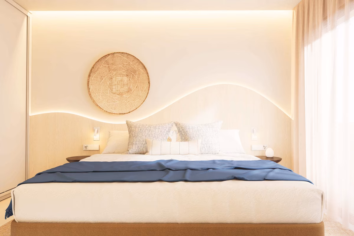 Bedroom with a curved headboard wall and soft lighting