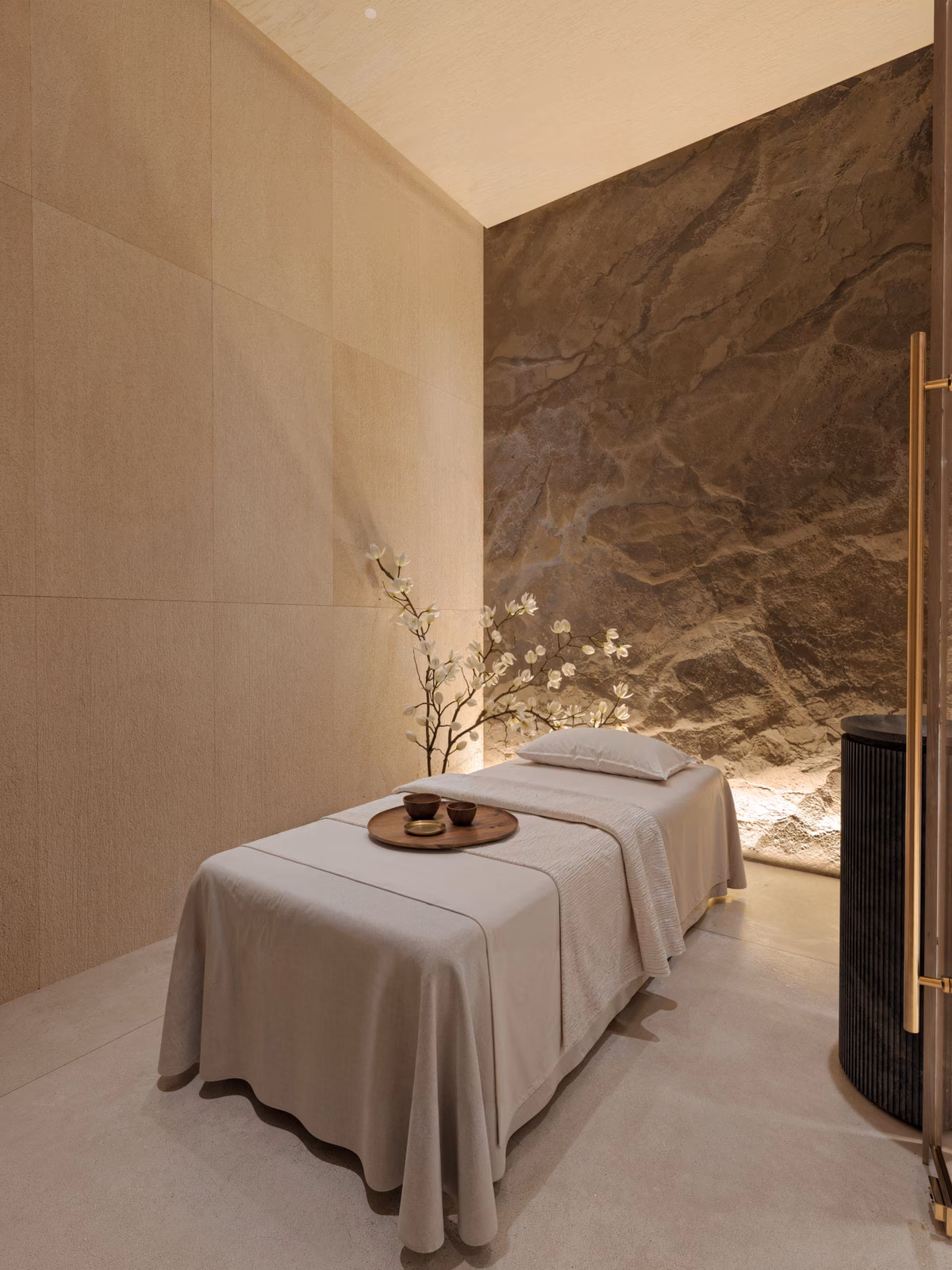 Spa treatment room with a stone feature wall