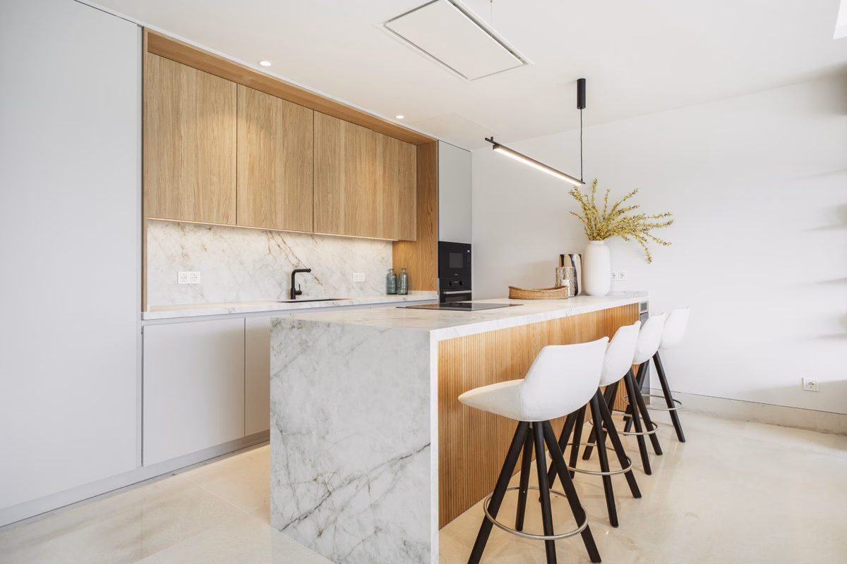 Kitchen with marble island in an Aloha Forest apartment