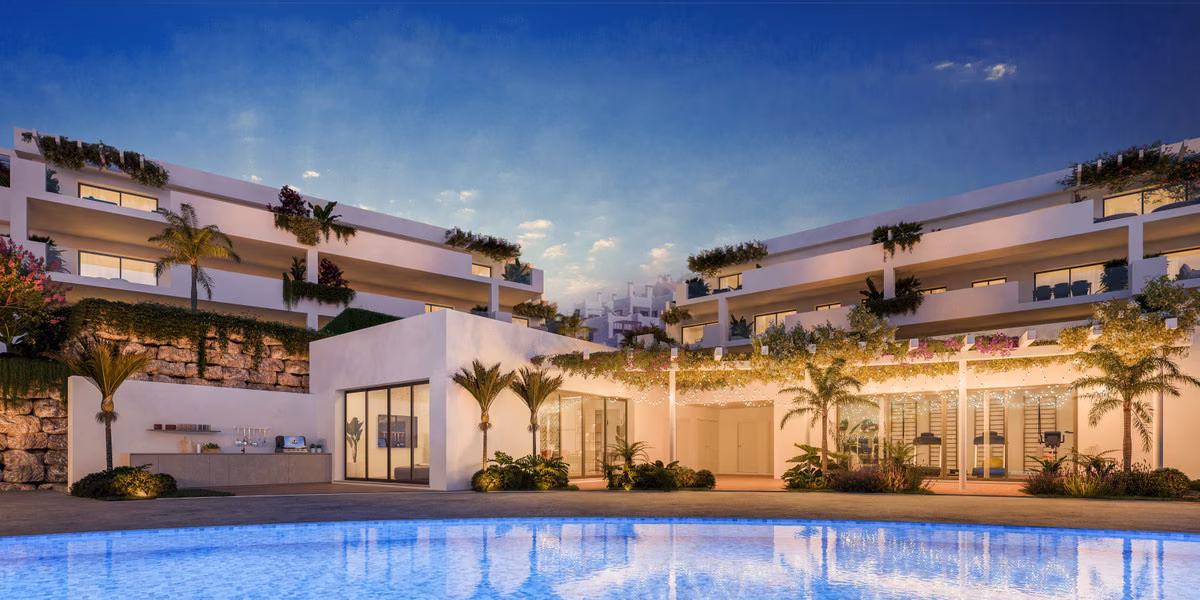 Tiered white blocks above the pool at dusk, with bougainvillea along the roof edges