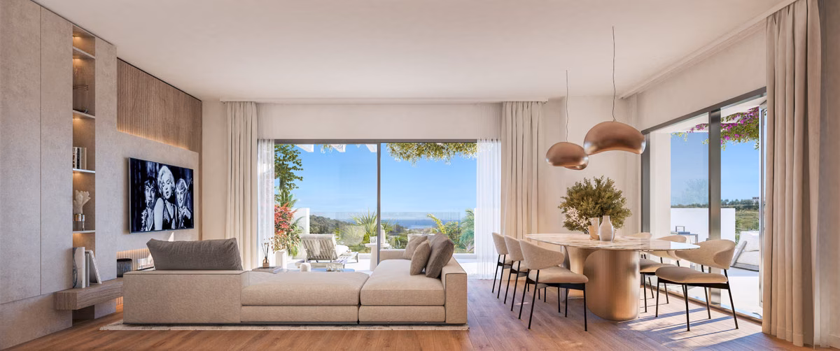 Living and dining room opening to a terrace with a sea view