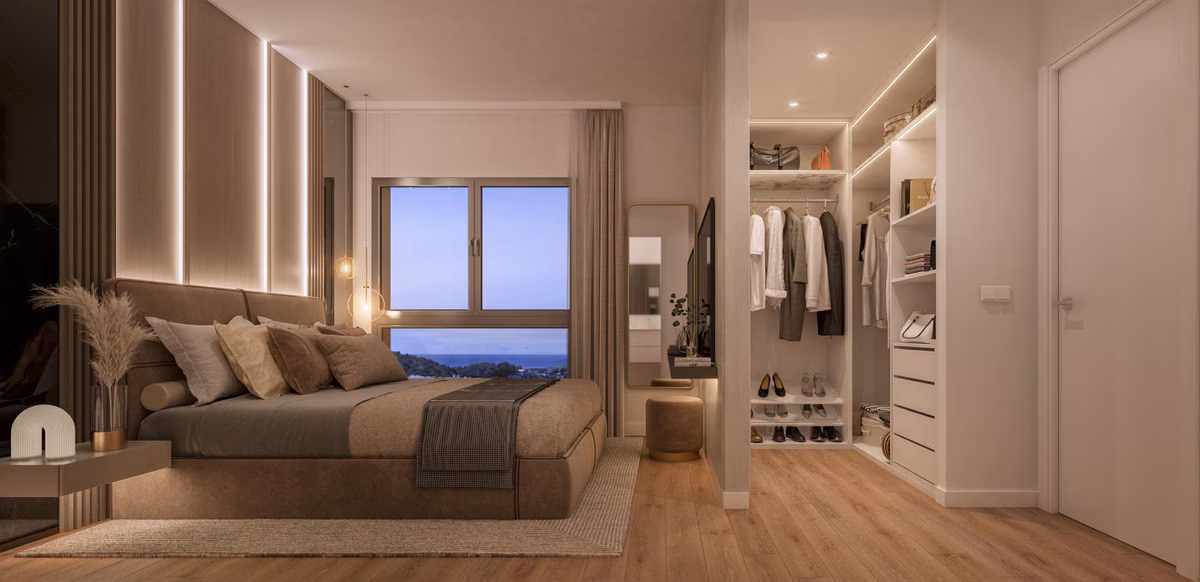 Bedroom with a walk-in wardrobe and a window to the sea