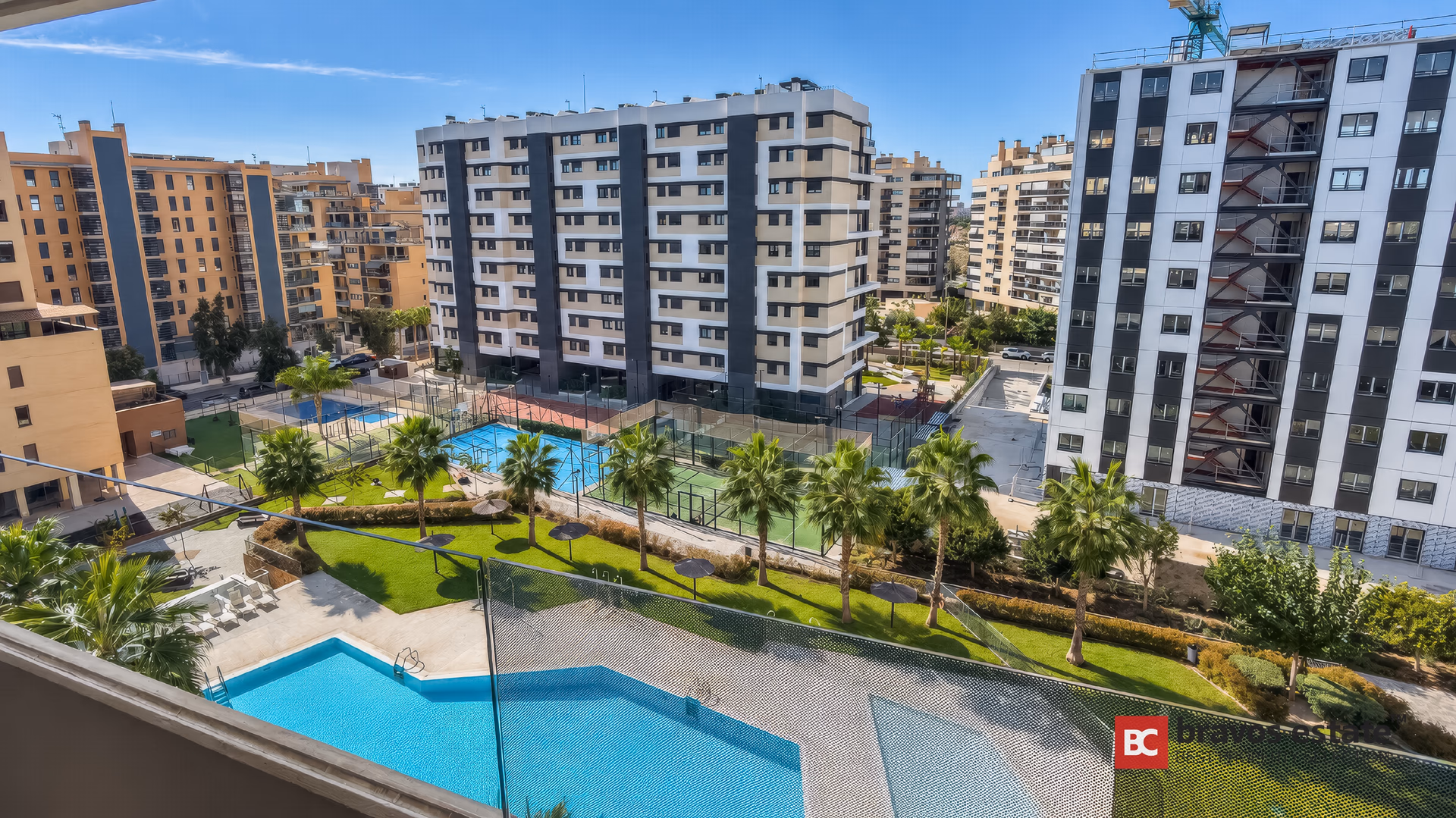 View from the main terrace down onto the communal pools and landscaped gardens