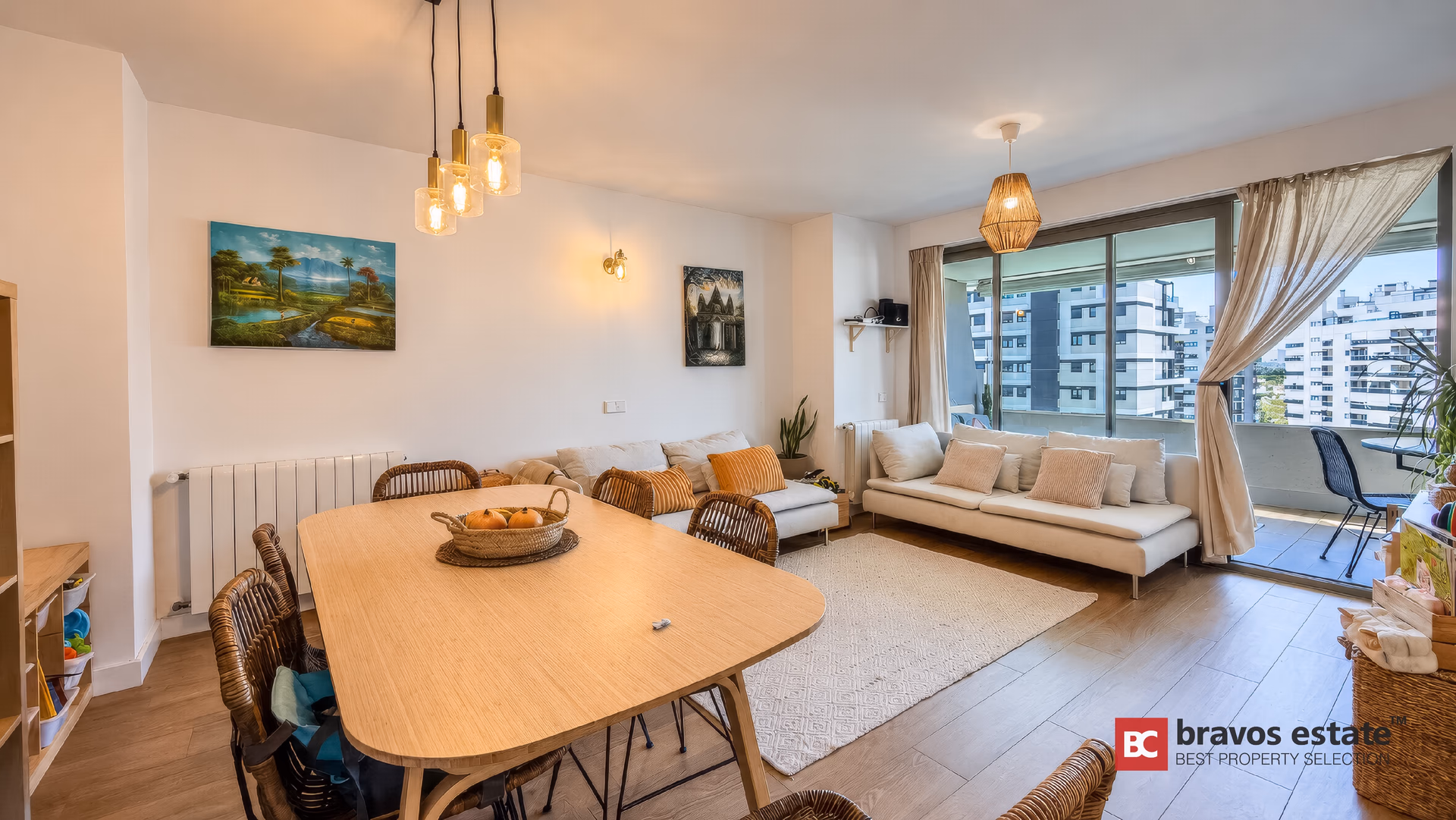 Dining area by the sliding doors to the terrace, pendant lights above the table