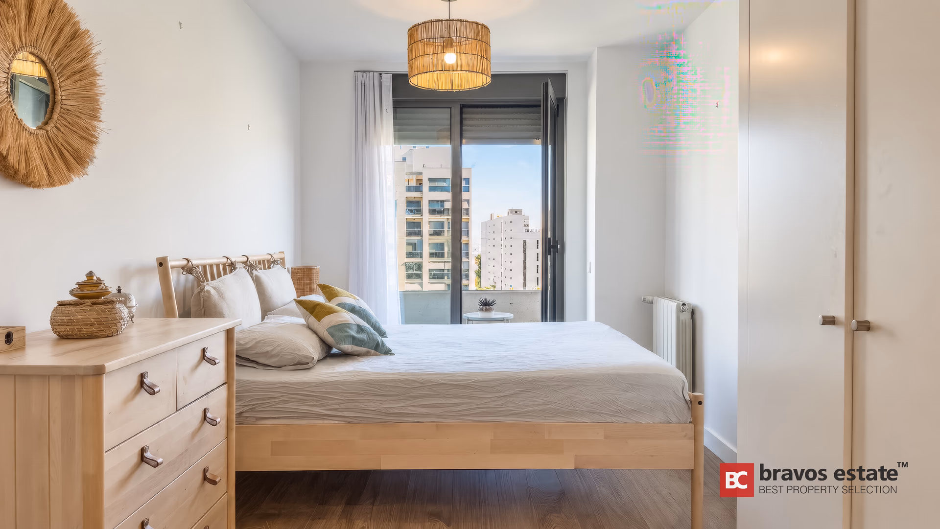 Main bedroom with a double bed, chest of drawers and the door to its balcony