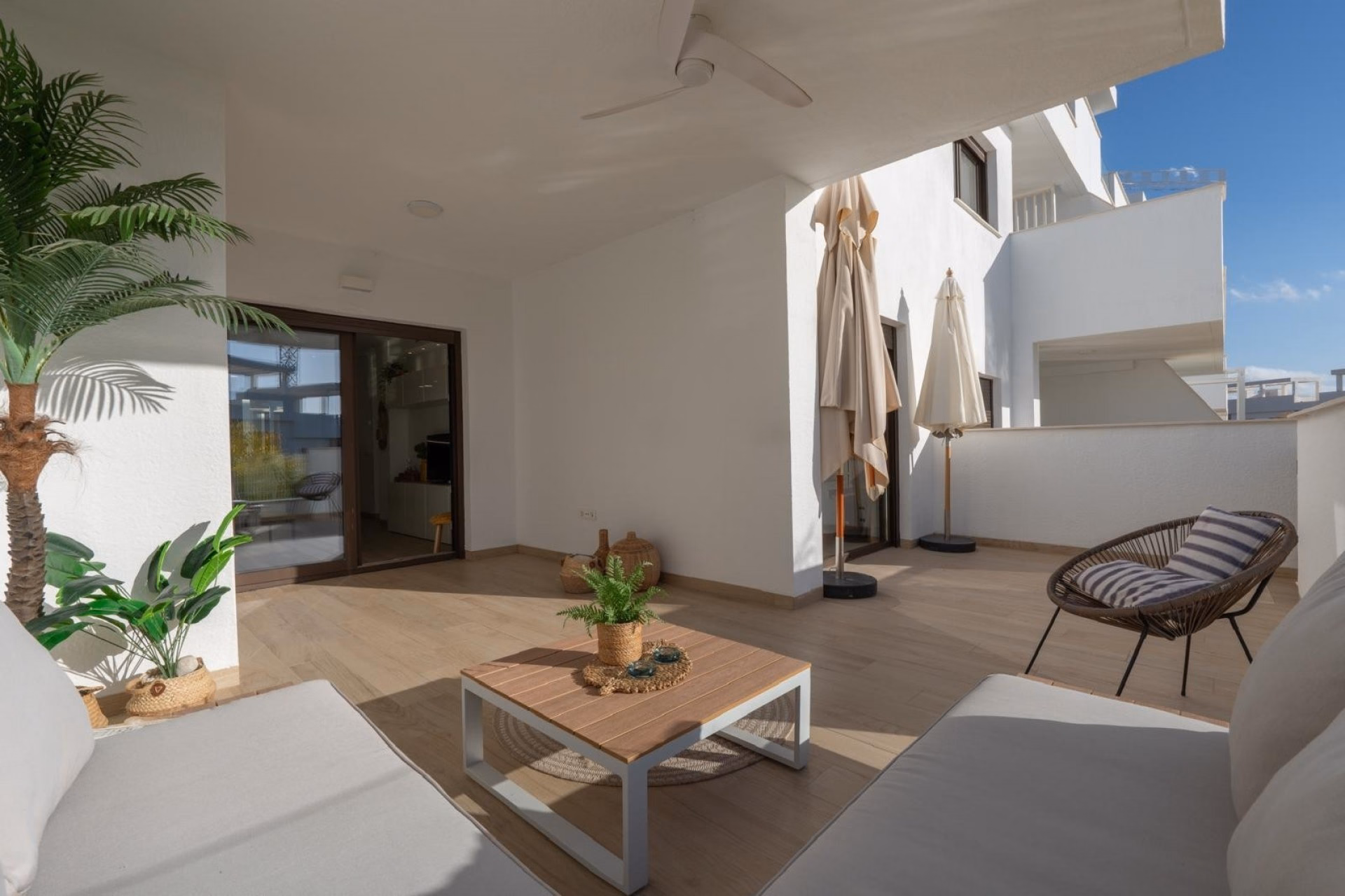 Terrace with a lounge set and the glazed doors of the living room