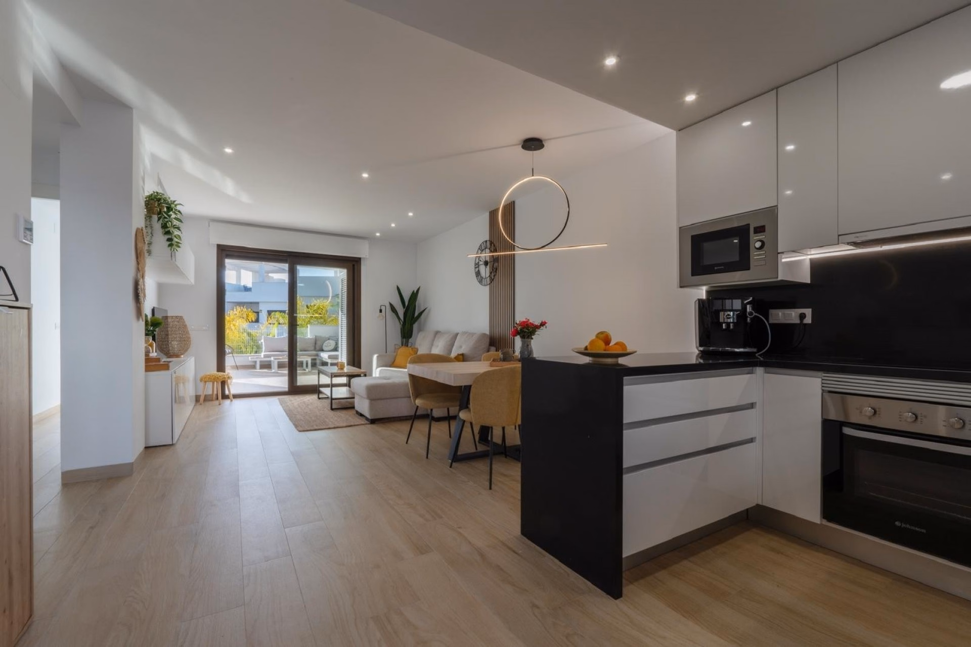 Open-plan living room with the American-style kitchen and dining table