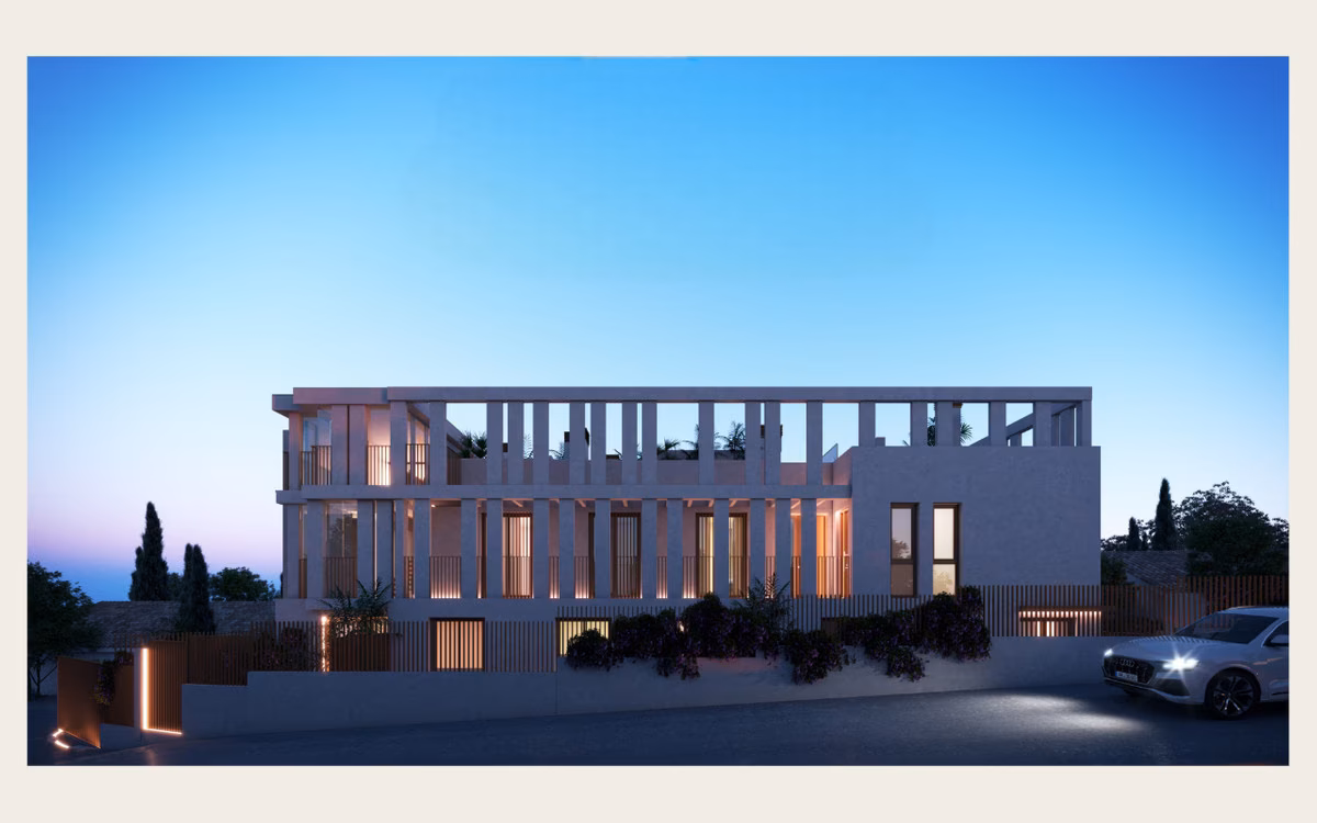 White colonnaded façade of Bastion Sea Views lit at dusk, Montemar
