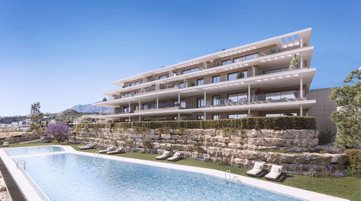 Terraced apartment building with outdoor pool and loungers at Capri, Estepona
