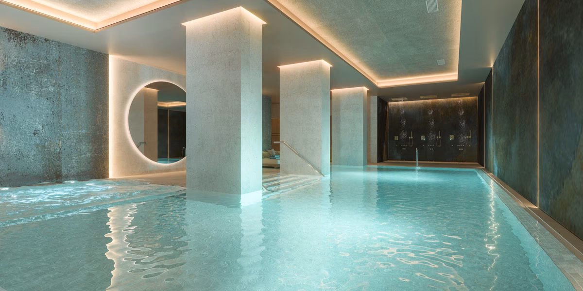 Indoor pool with columns and spa lighting at Capri, Estepona