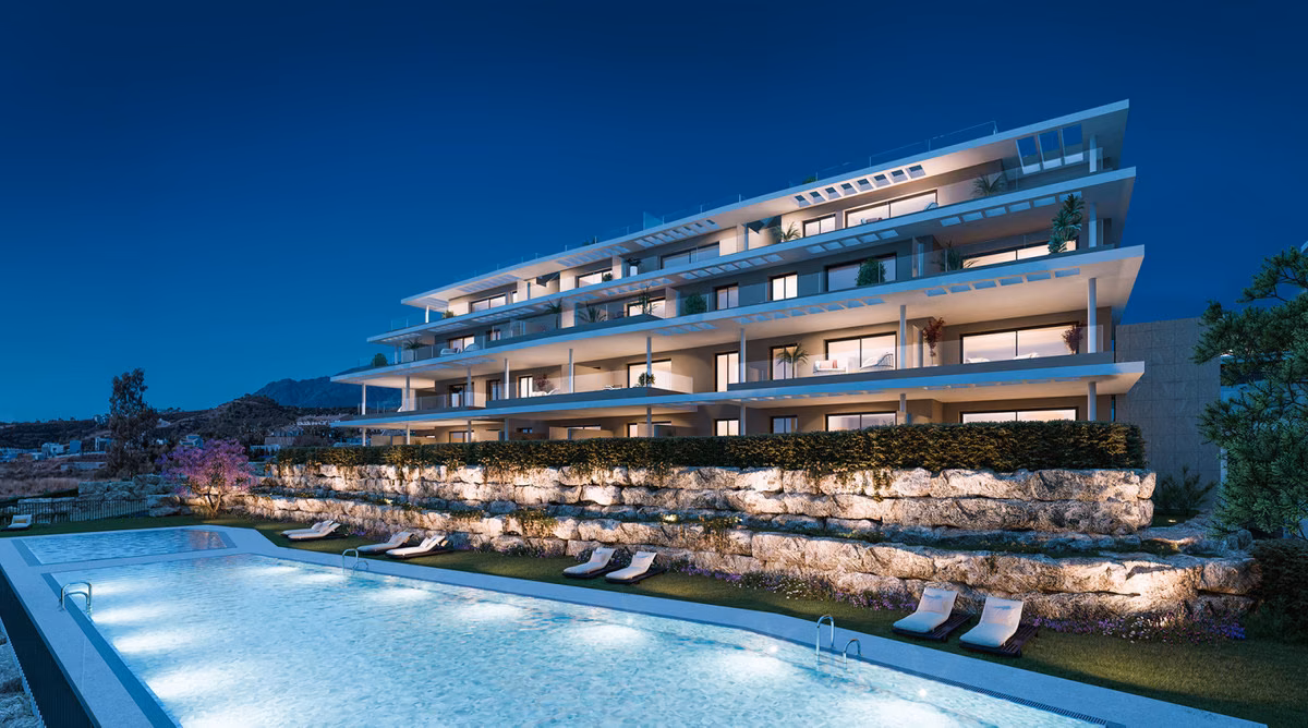 Apartment building and outdoor pool at dusk at Capri, Estepona
