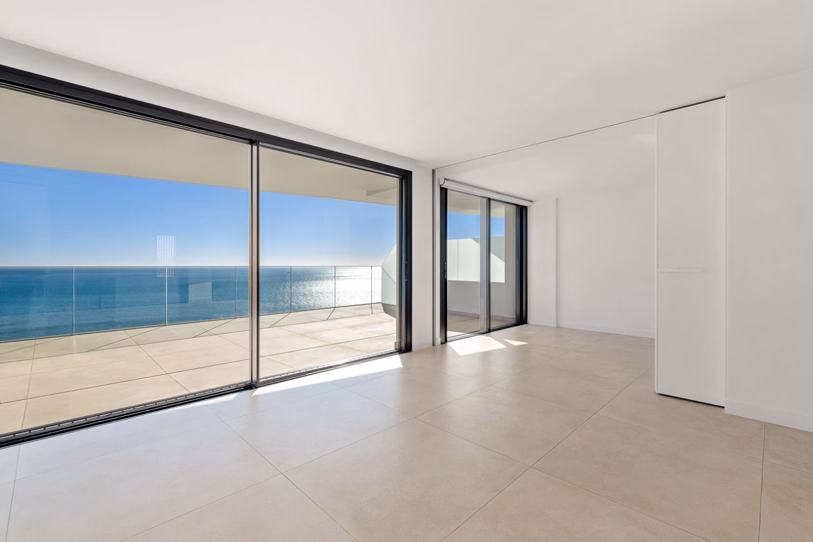 Living space opening onto a terrace with direct Mediterranean views