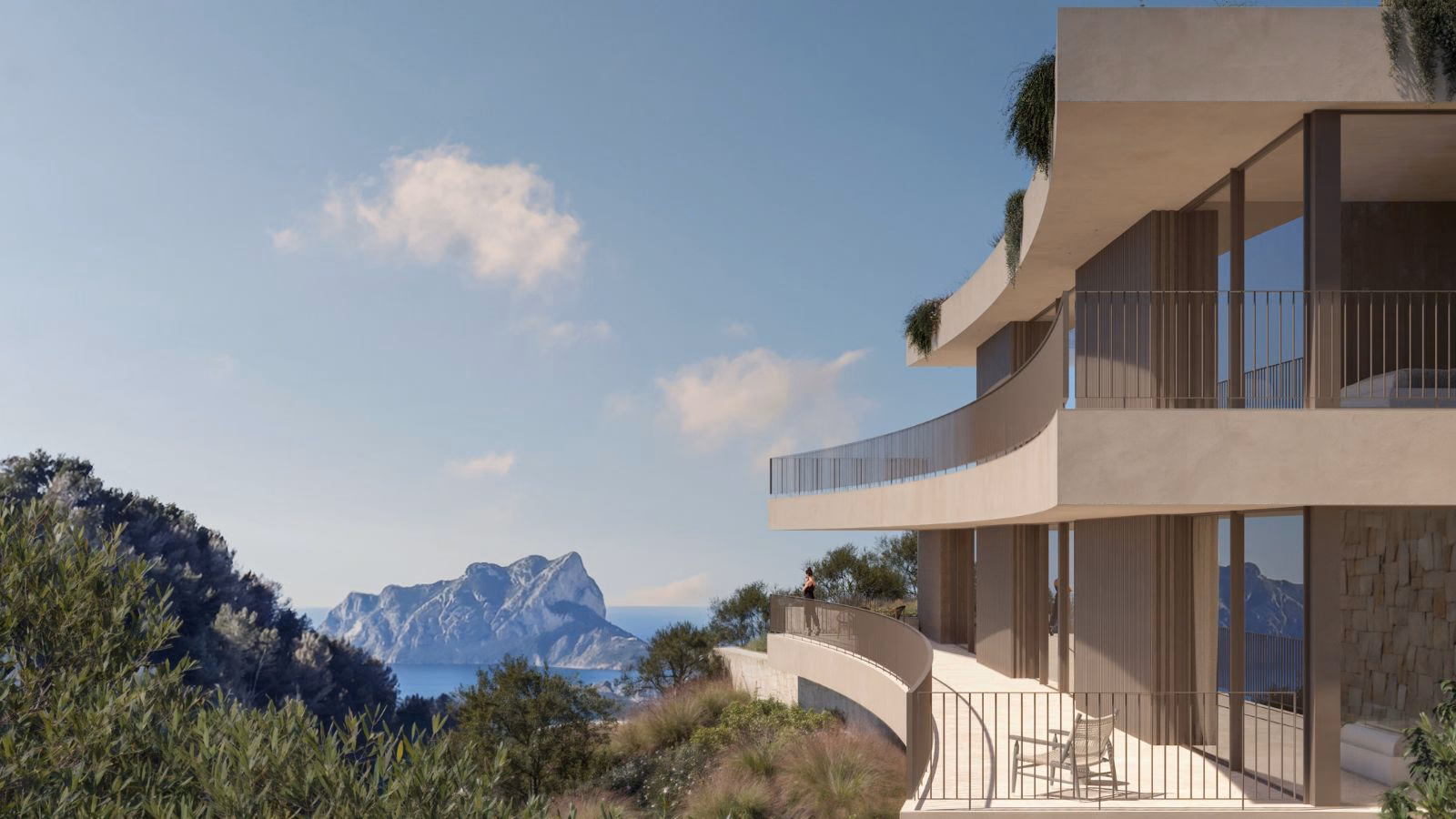 Side terrace of the villa with a curved balustrade and a view to the Peñón de Ifach