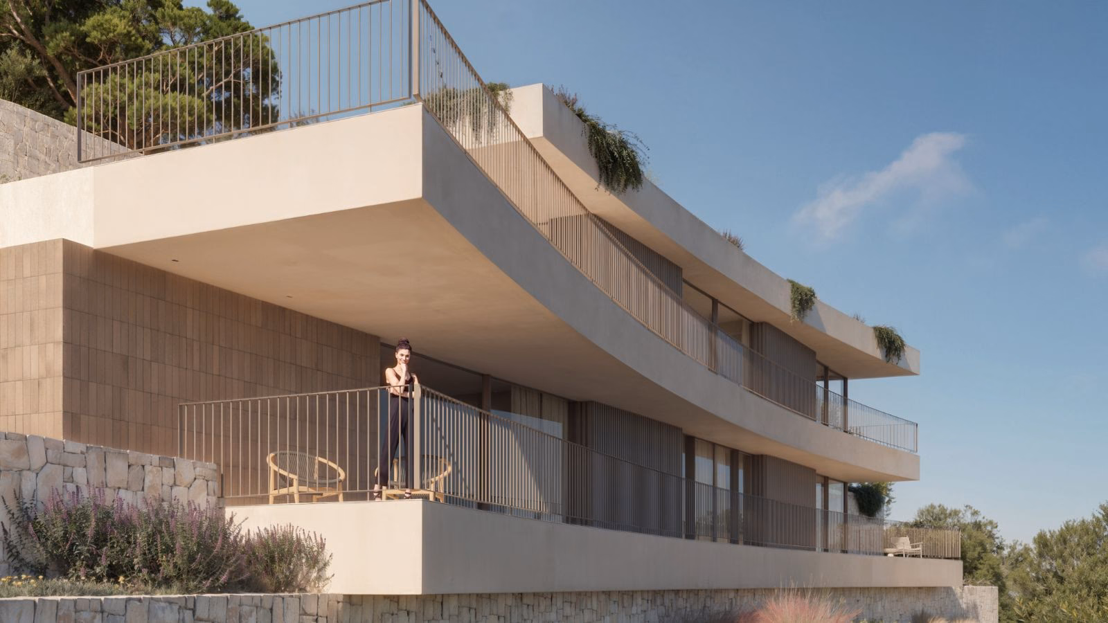 Upper terrace with a metal balustrade and planting along the edge of the roof