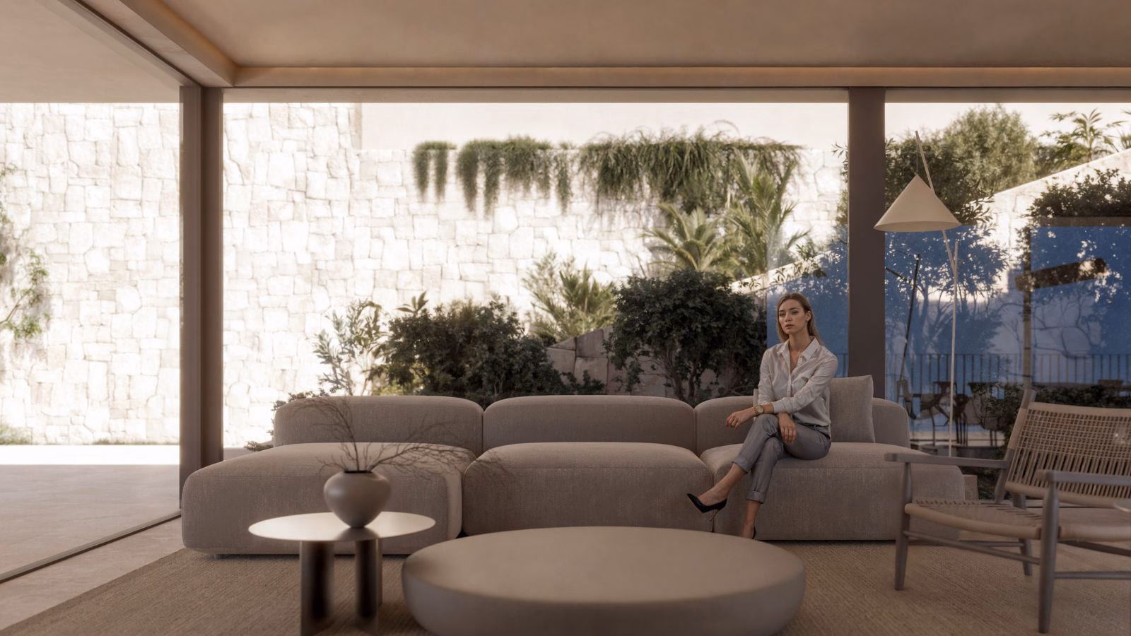 Lounge with a sofa and low tables, opening onto a terrace under hanging plants
