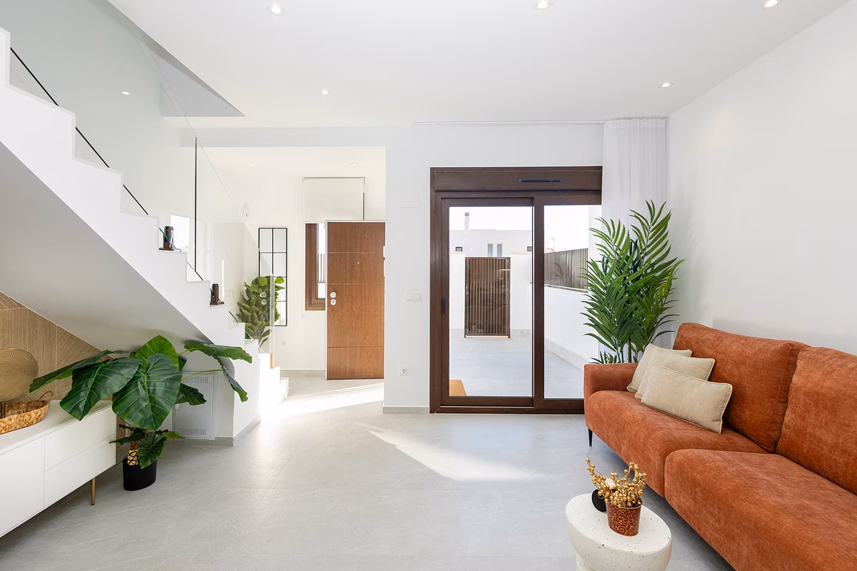 Living area with the staircase and a glazed door to the terrace