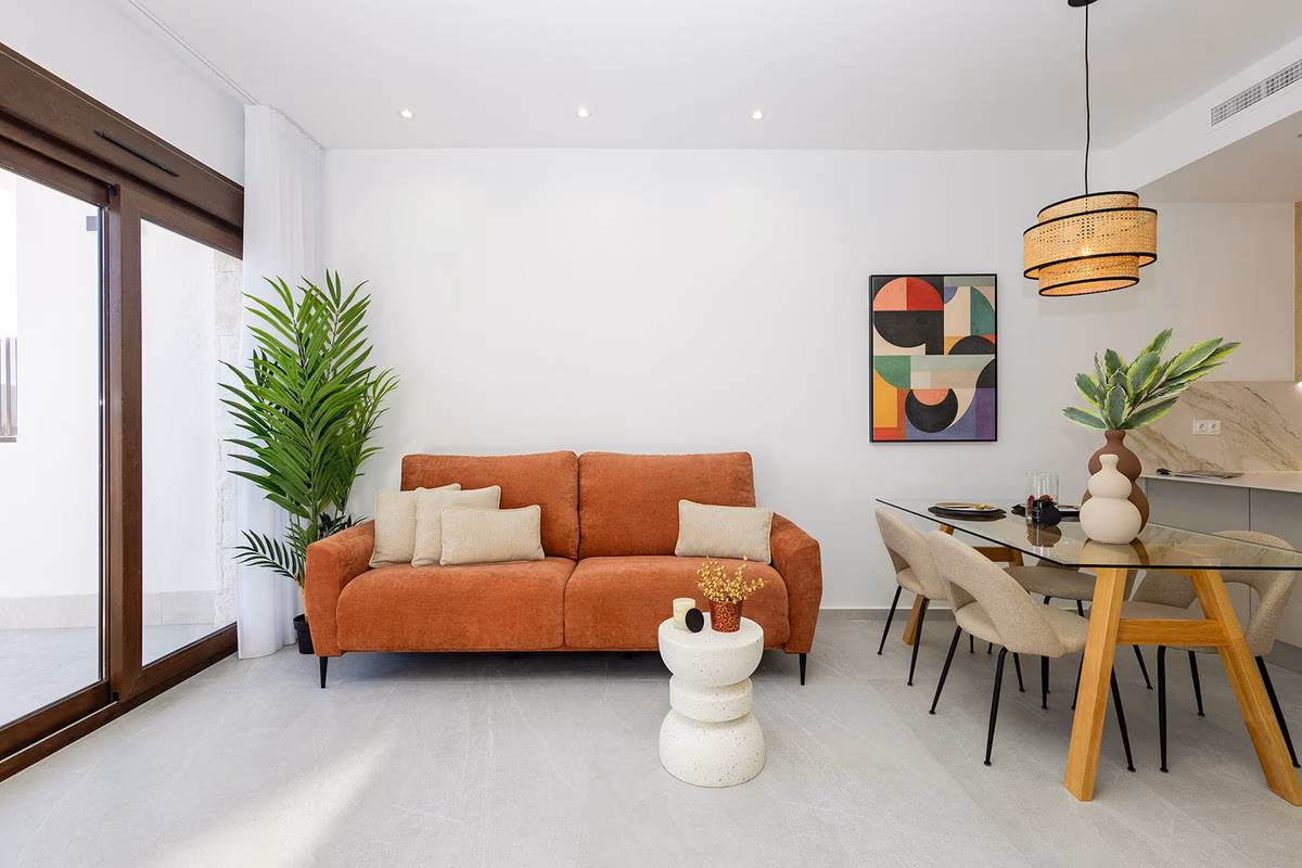 Sofa and glass dining table beside the sliding doors