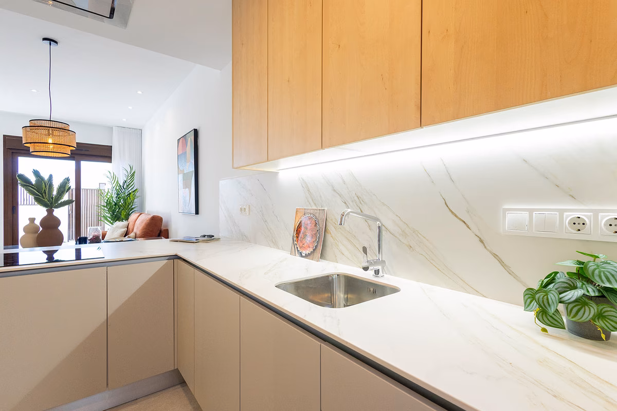 Kitchen worktop with marble-effect splashback and under-cabinet lighting