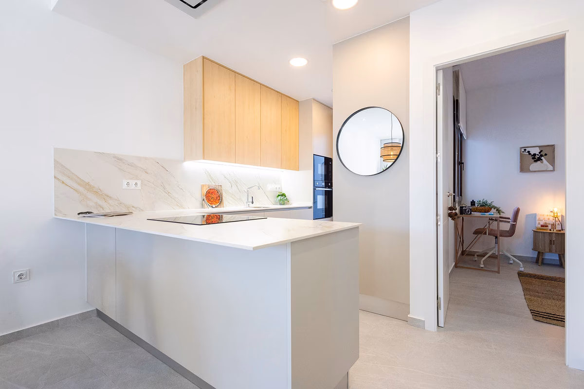 Kitchen peninsula with a door to a ground-floor bedroom set up as a study
