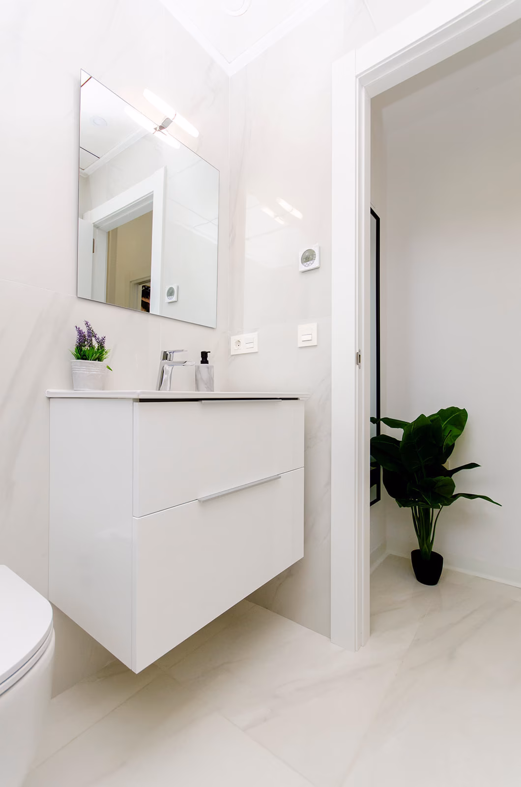 Bathroom with wall-hung white vanity unit