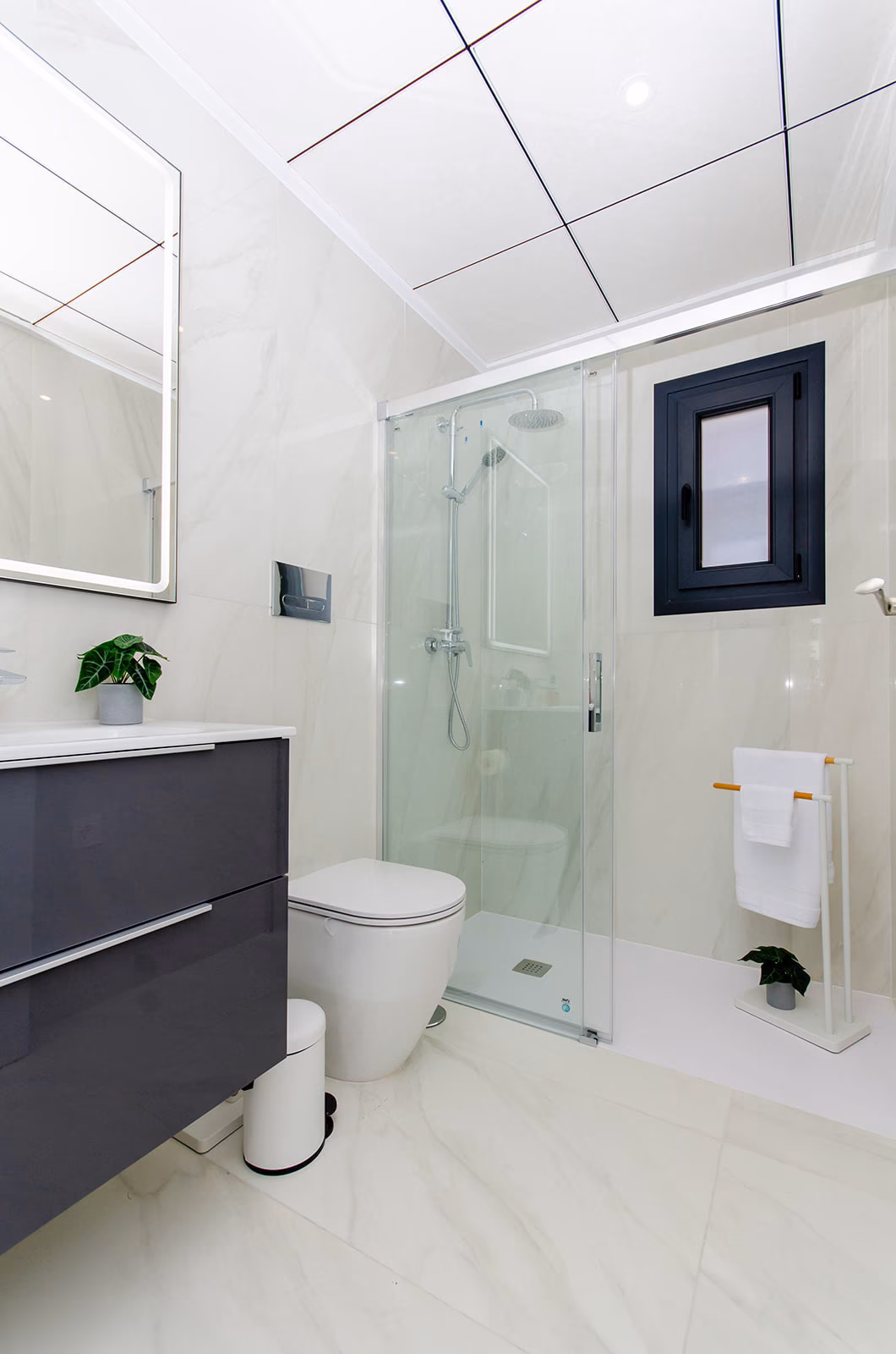 Bathroom with grey vanity and glass shower screen