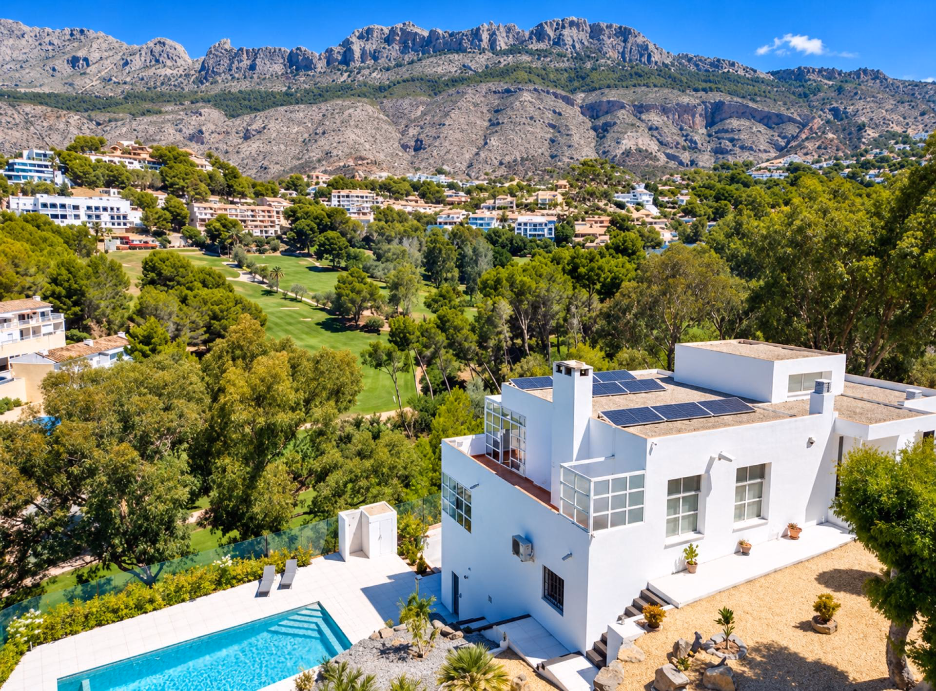The white villa and its pool above the fairways of Club de Golf Don Cayo