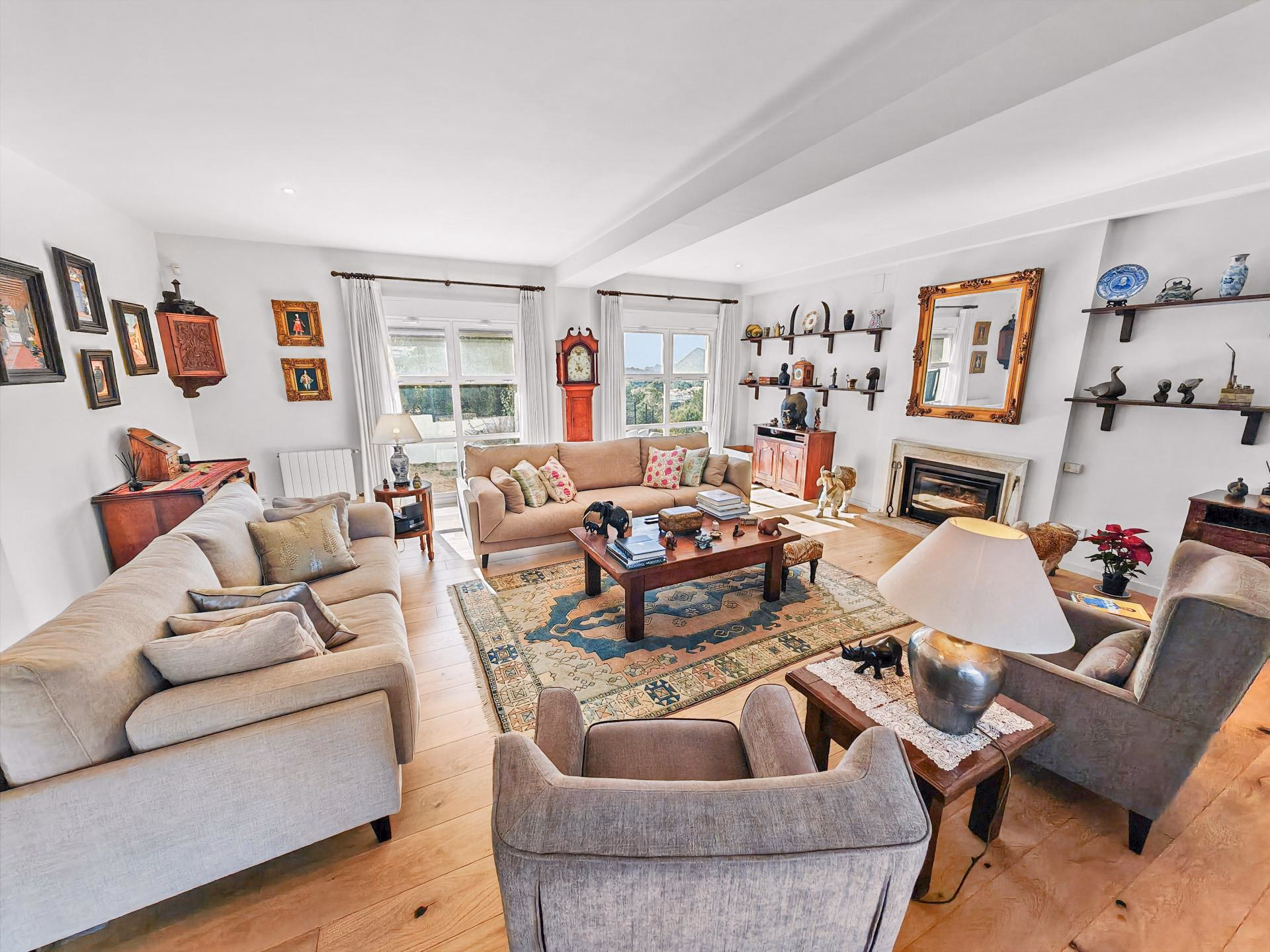 Living area with a fireplace, sofas and wooden flooring