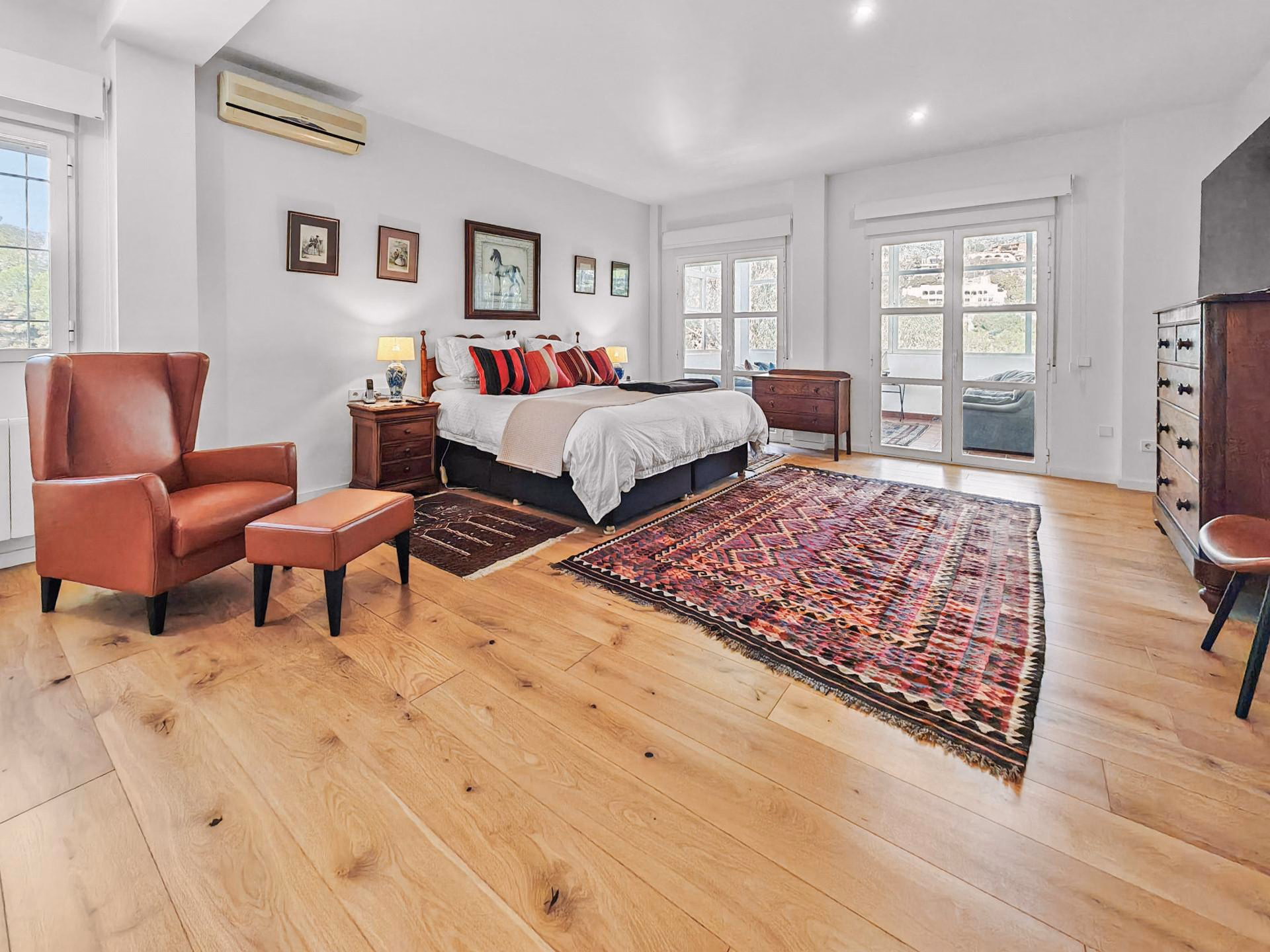 Main bedroom with a double bed and windows onto the golf course