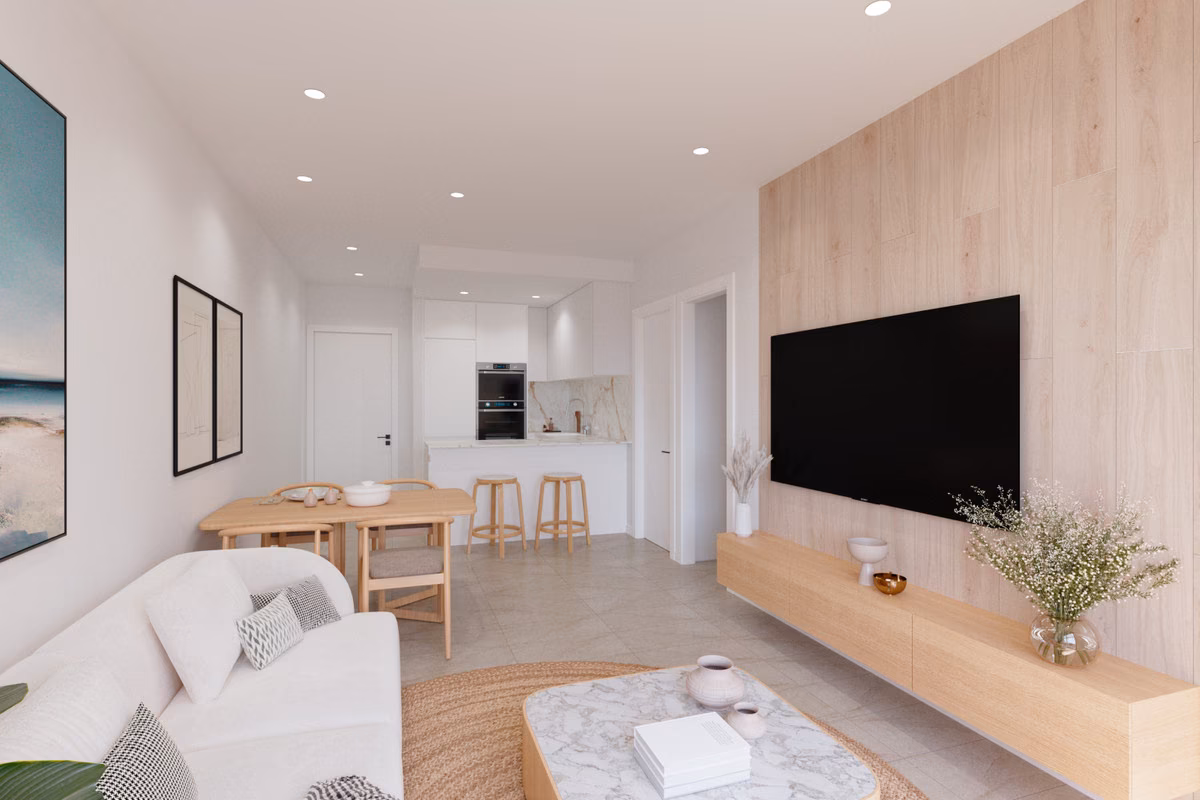 Séjour ouvert avec mur TV et cuisine en arrière-plan à Edificio Marcelina