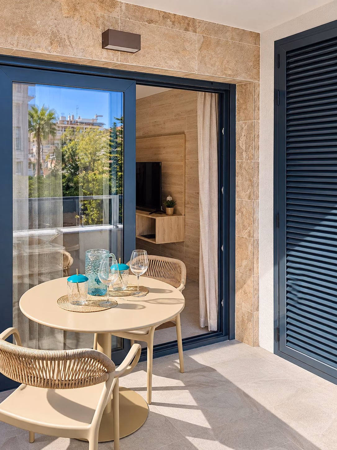 Table de terrasse vue par les portes ouvertes dans un appartement témoin meublé
