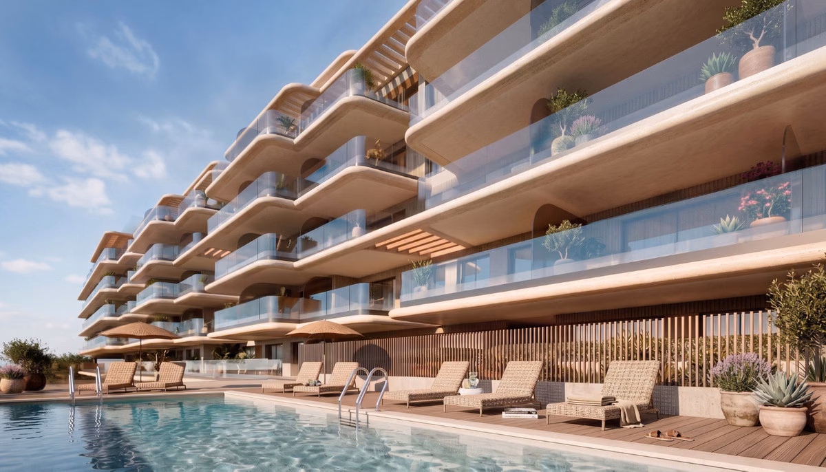 Gemeinschaftspool mit Sonnenliegen vor der gestaffelten Fassade mit Balkonen