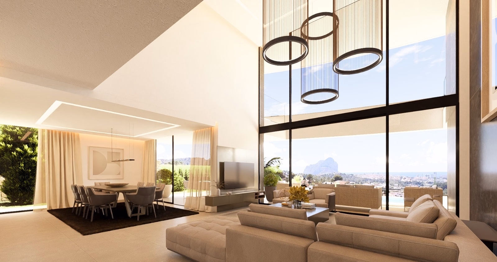 Double-height living room with tall windows and a view towards the sea