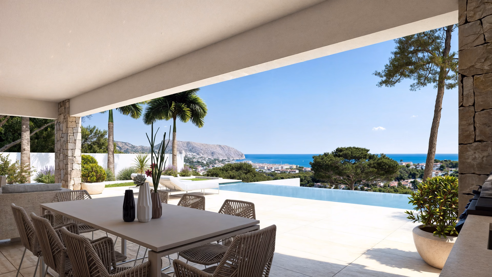 Überdachte Terrasse mit Esstisch, offen zum Pool, mit Blick über die Bäume aufs Meer