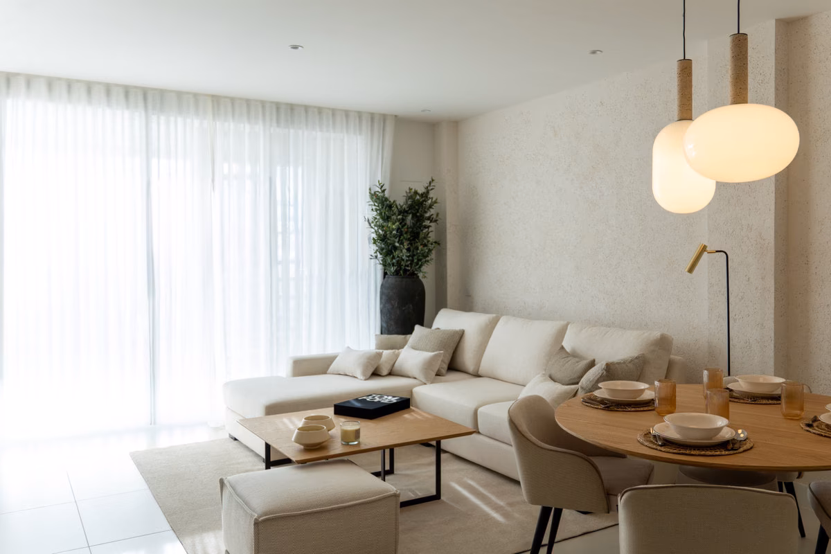 Open-plan kitchen-lounge behind large glazing